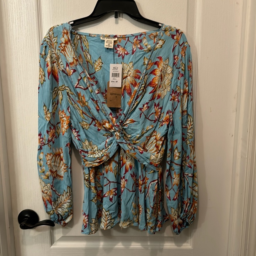 NWT. Beautiful blue floral blouse in small.